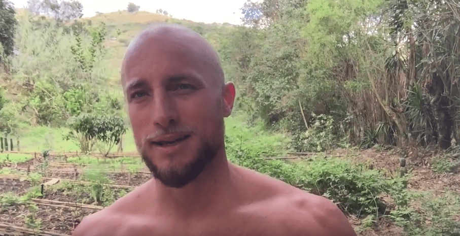 A man outdoor with the garden at the background.