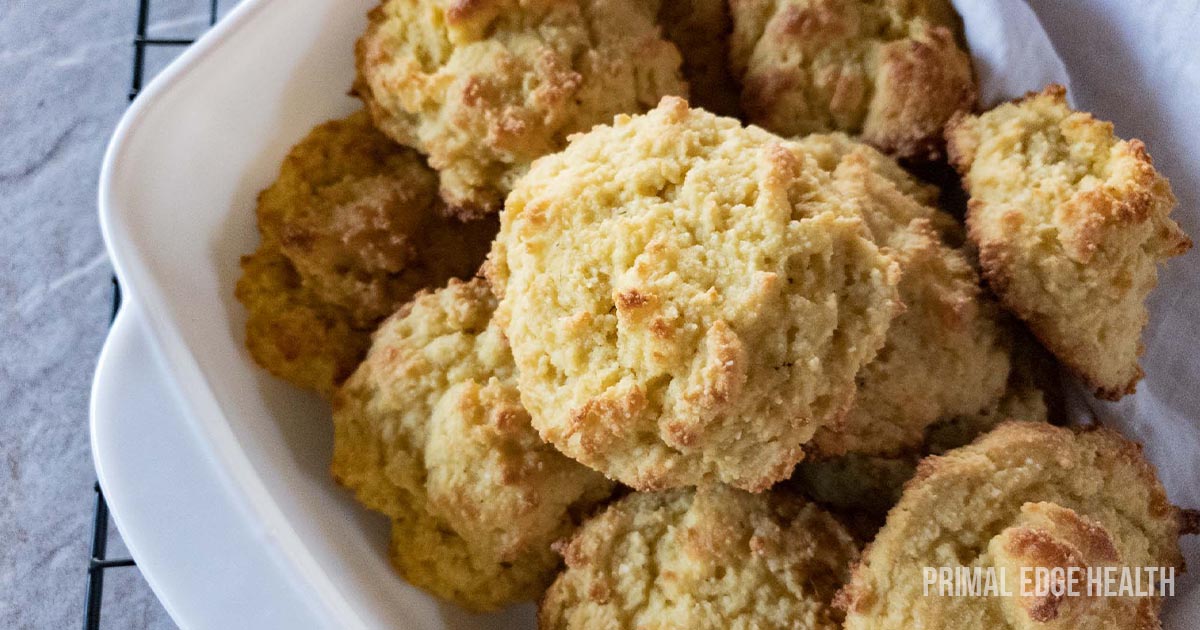 Buttermilk biscuits with almond flour in white dish on cooling rack.