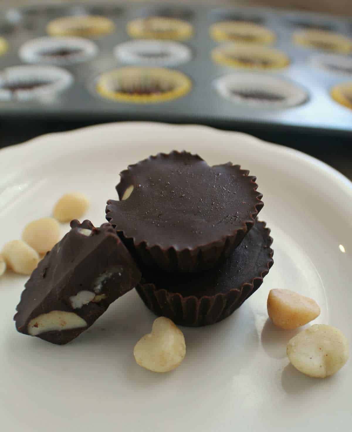 Keto chocolate peanut butter cups displayed on a white plate.