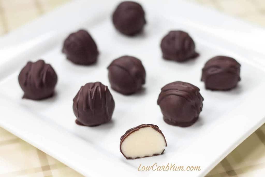 Pieces of chocolate truffles arranged in a white plate.