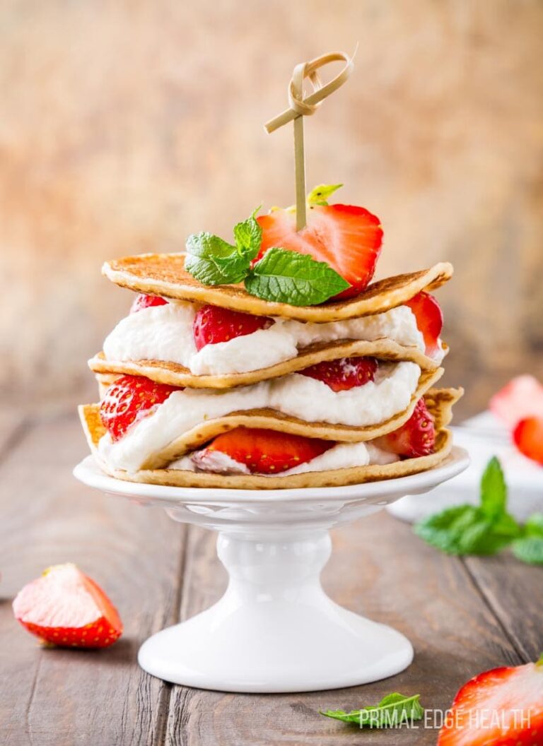 Keto Strawberry Shortcake served with garnish on a wooden surface.