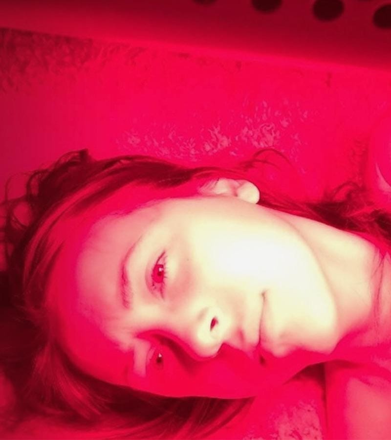 A picture of a woman in red light.