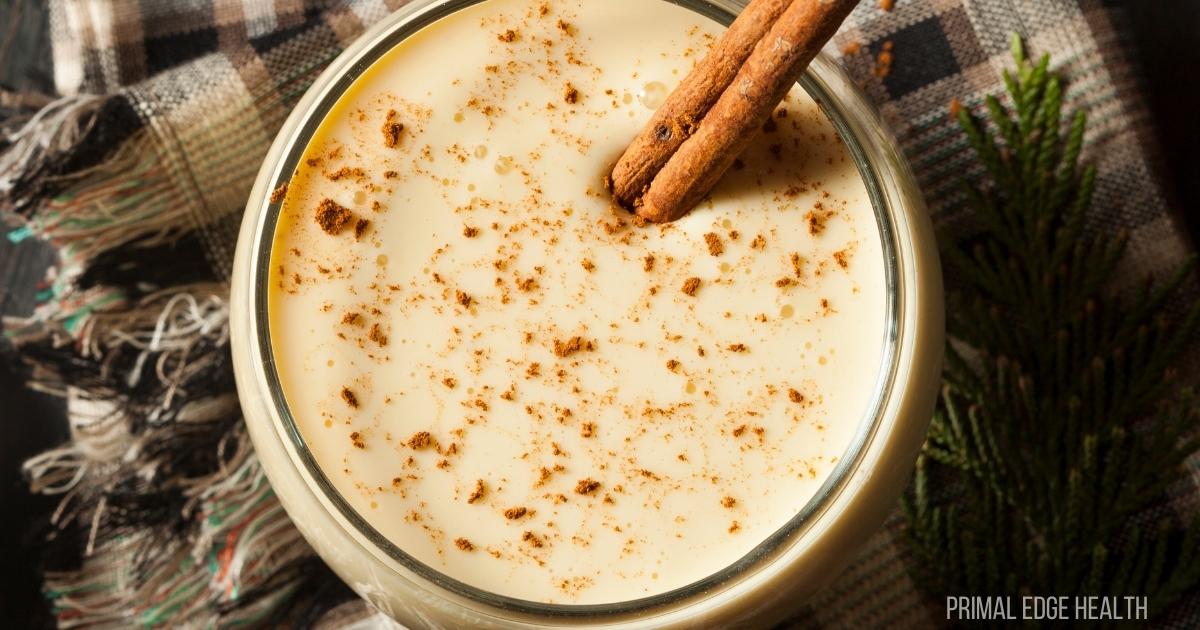 A serving of eggnog in a round glass.