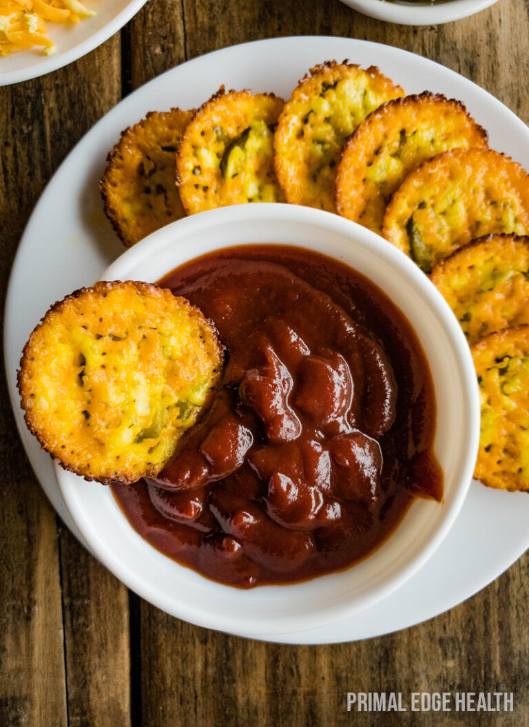 Plate of crisps served with a side of tomato dipping sauce.