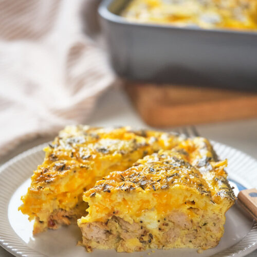 A plate with two servings of egg casserole containing vegetables and meat.
