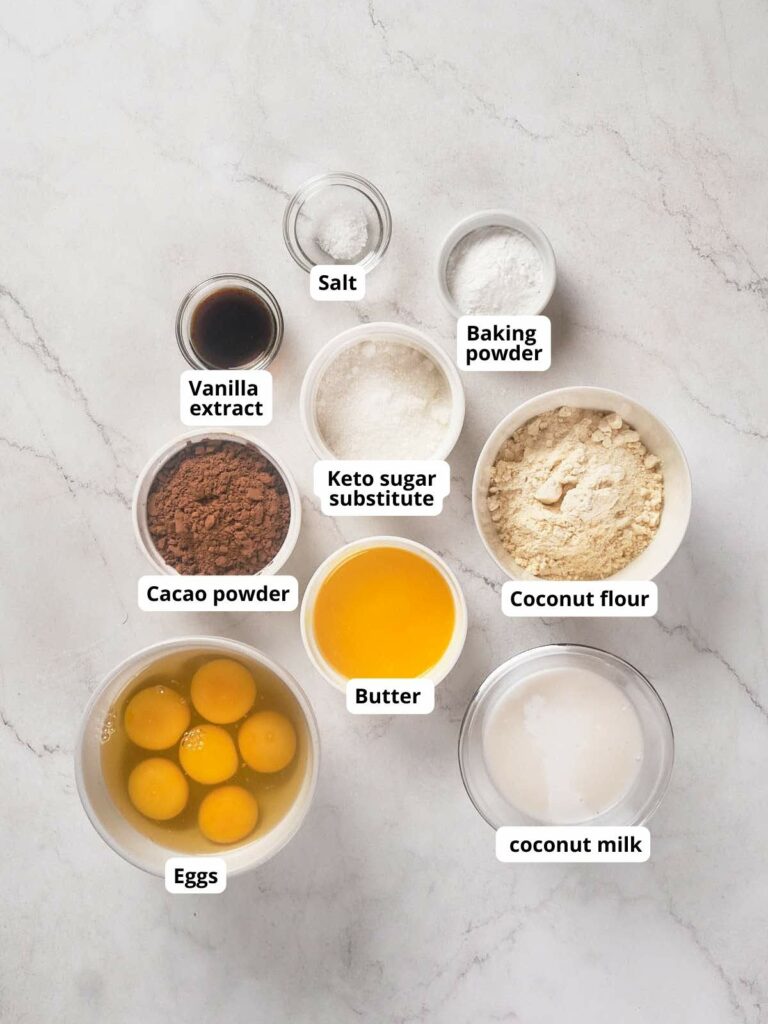 Image showing labeled baking ingredients arranged on a marble surface.