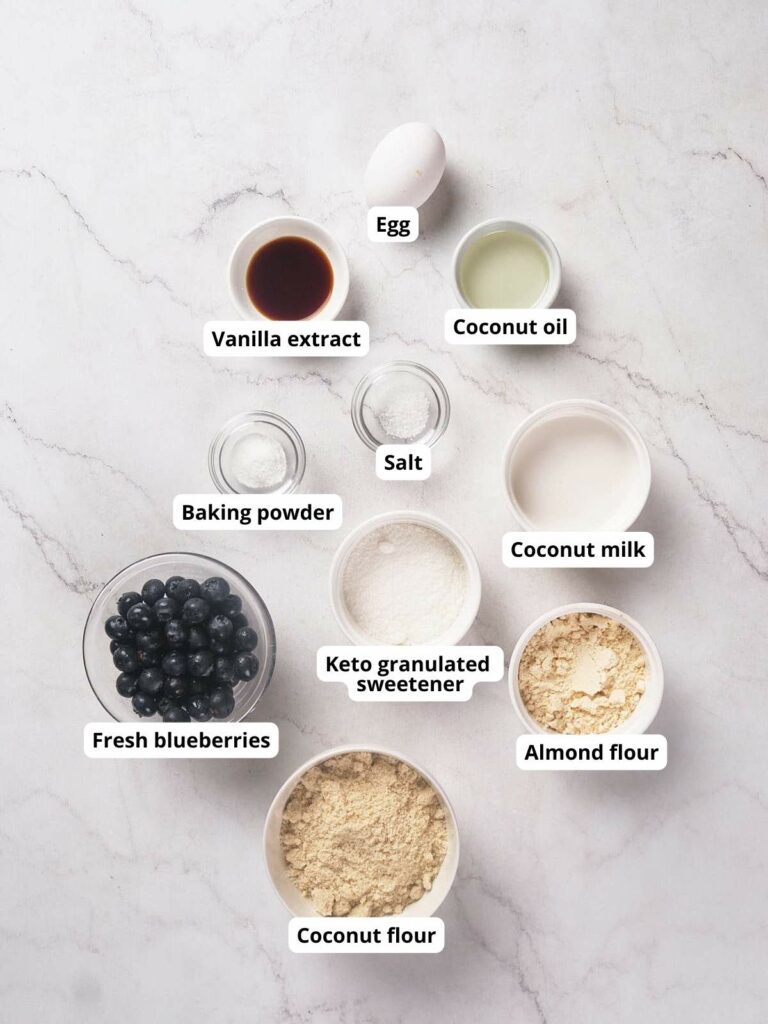 Ingredients for a keto scones recipe are arranged on a marble surface.
