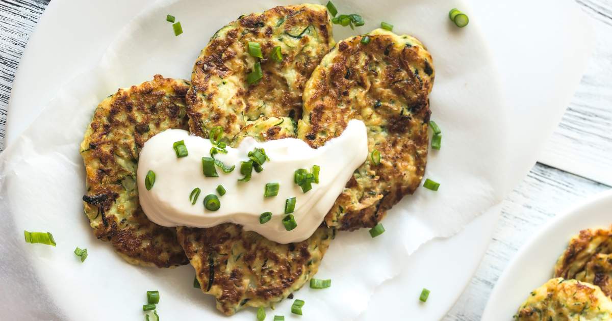 Savory Pancakes with Fennel and Feta in a stack on white plate.