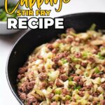 A skillet filled with cabbage stir fry, featuring minced meat and chopped vegetables.