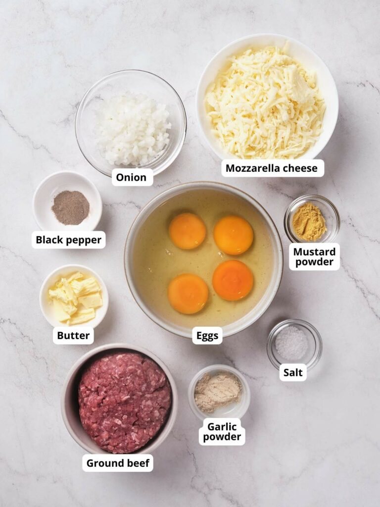 A top-down view of ingredients in bowls on a marble surface.