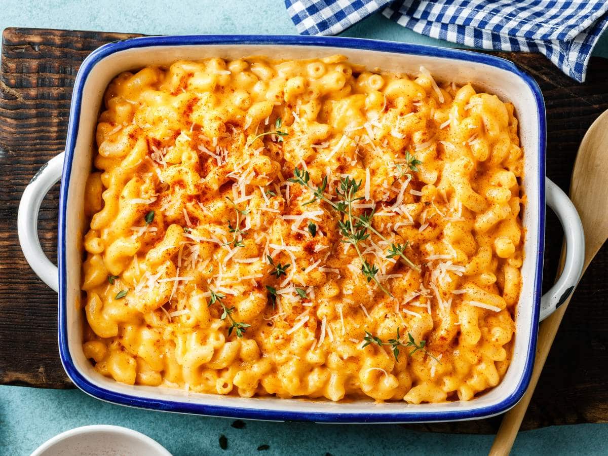 A baking dish filled with creamy baked macaroni and cheese topped with grated cheese.