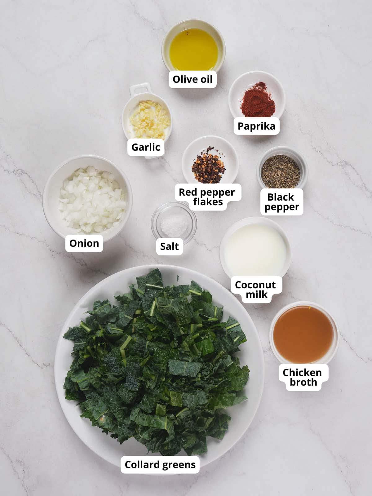 Ingredients for collard greens on a white surface.