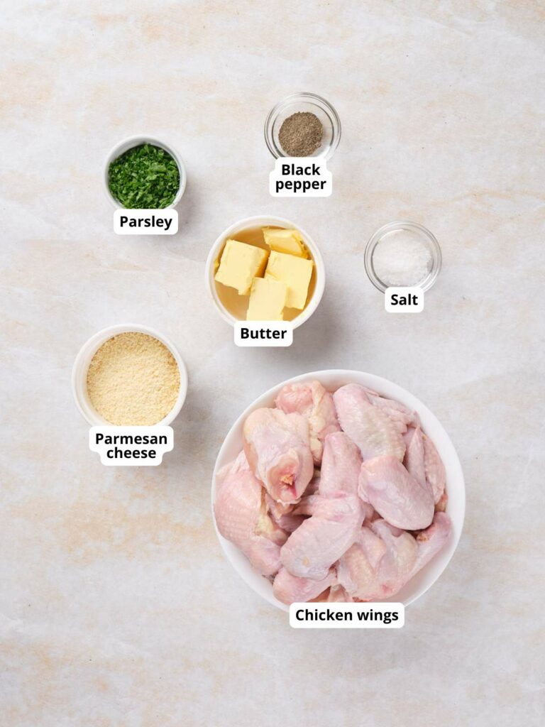 Ingredients for parmesan chicken wings arranged on a table:.