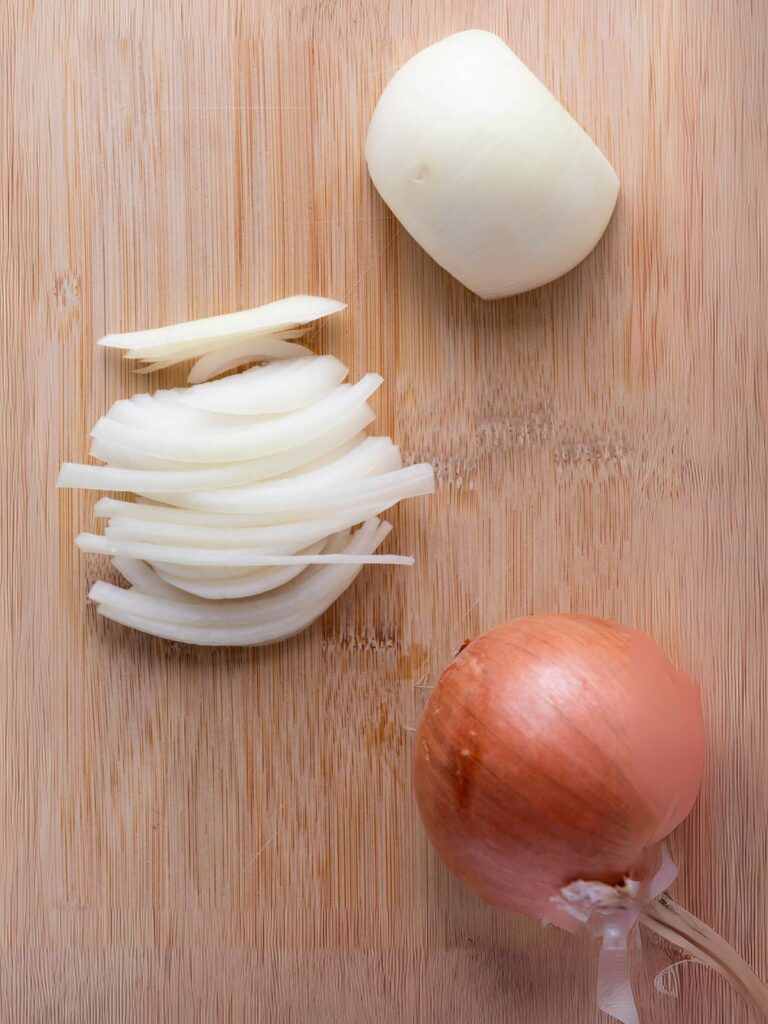 A cutting board with onions.