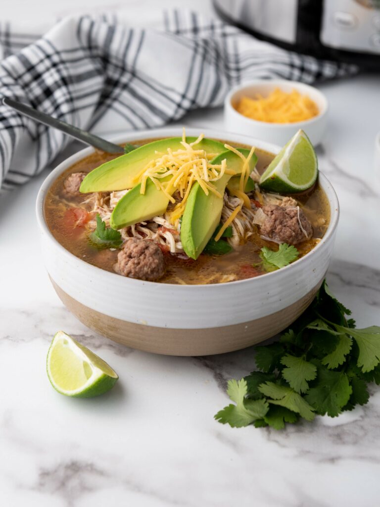 Bowl of taco soup on a marble surface.