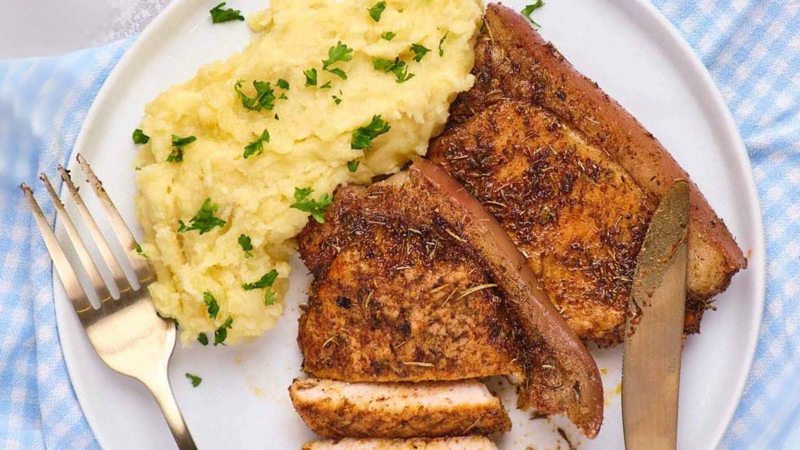 Air fryer boneless pork chops, mashed potatoes topped with parsley.