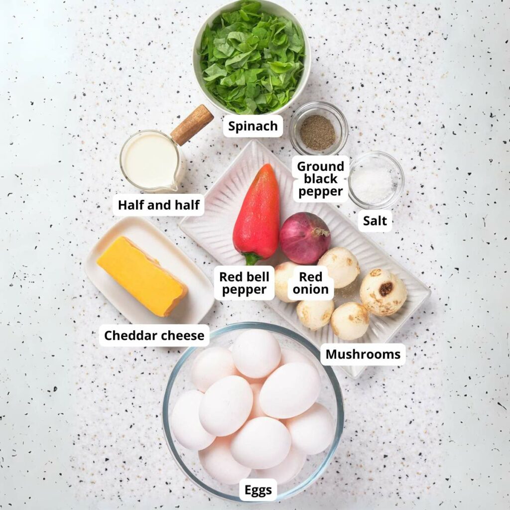 Ingredients for sheet pan omelet on a speckled surface.